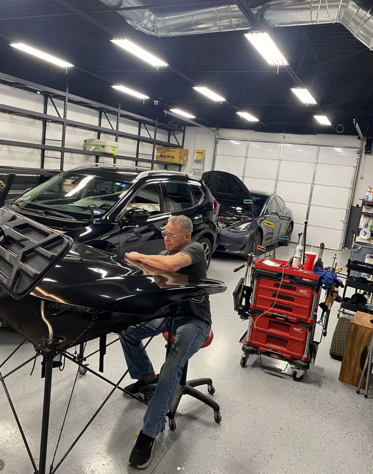 A DentPicks master technician working a panel in the Plano shop