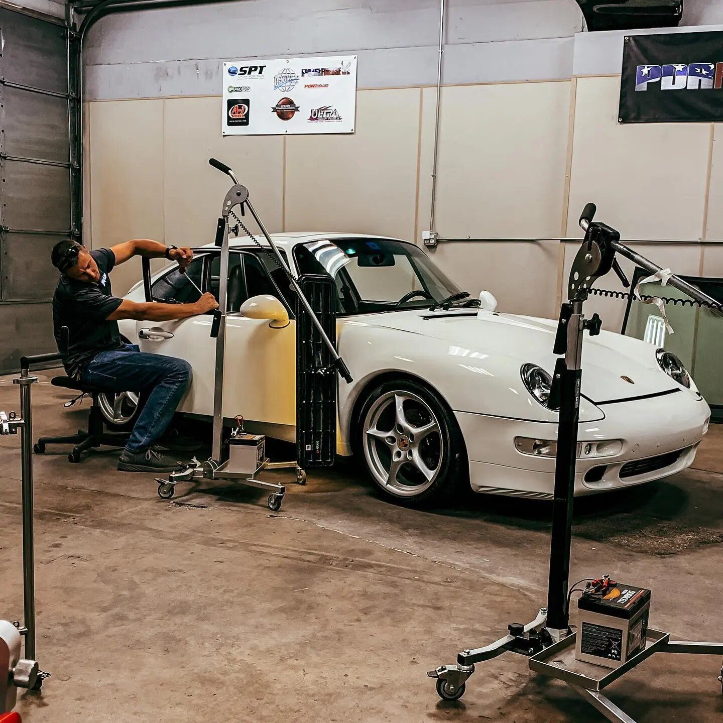 A DentPicks technician working a Porsche in the Plano shop